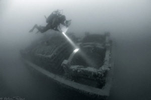 marine biologist diving on an artificial reef by Mathieu Foulquié 